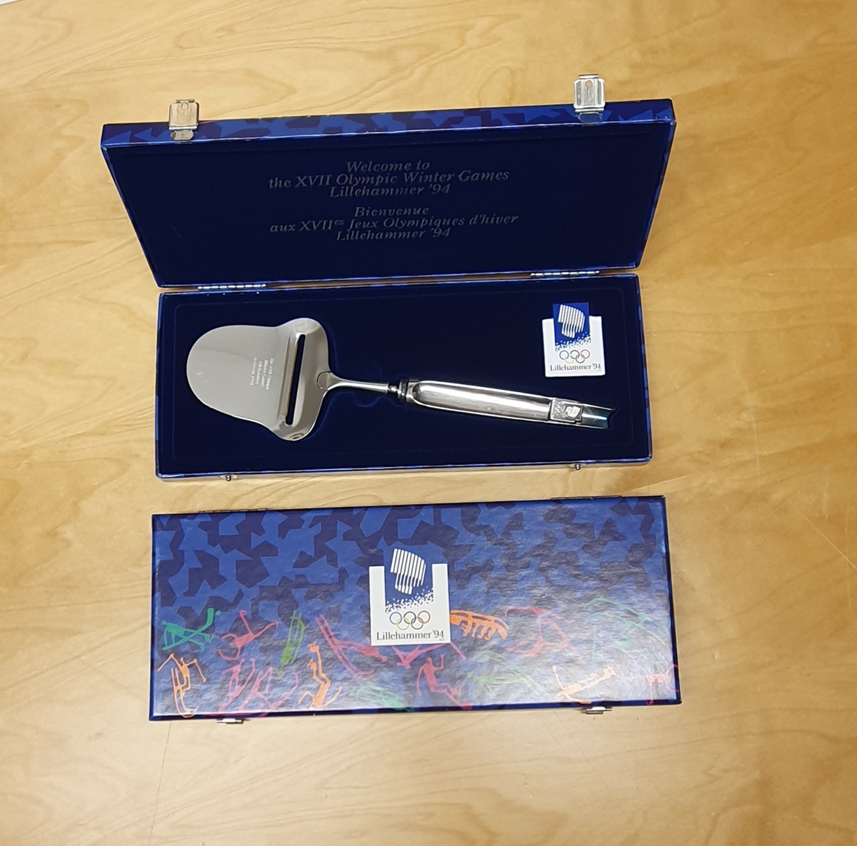 Cheese slicer with the Olympic emblem.

